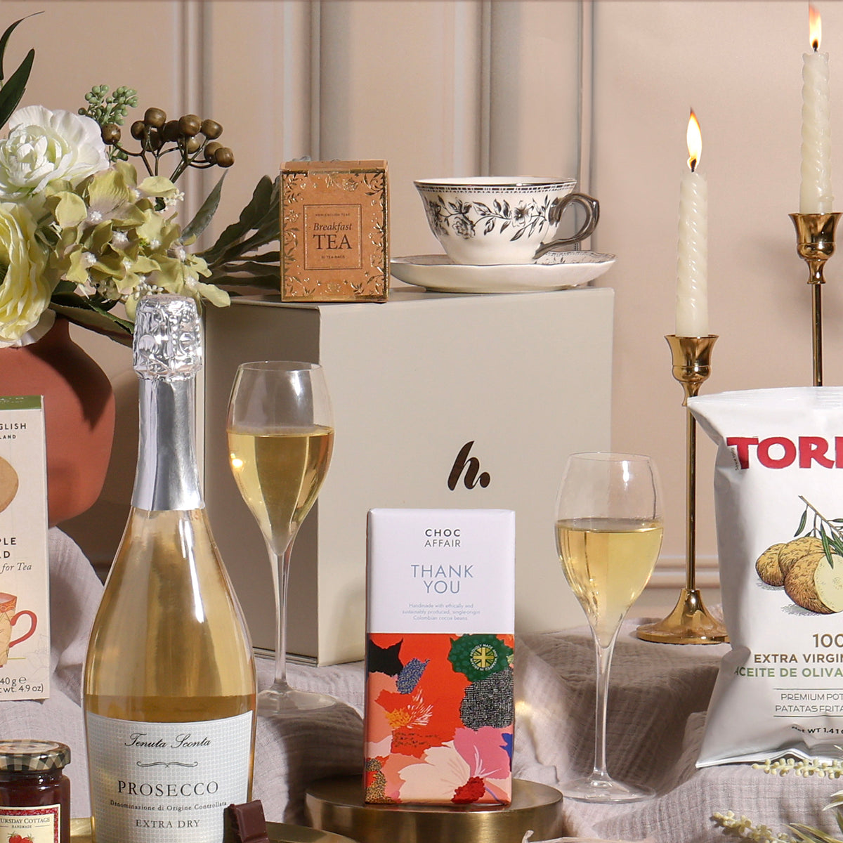 A luxury gift hamper to say thank you, showing contents including Prosecco, tea, chocolate and crisps.