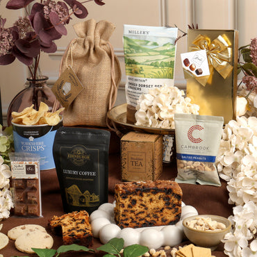 Alcohol-free treats displayed and ready to enjoy, featuring fruit cake, tea, crisps and chocolate.