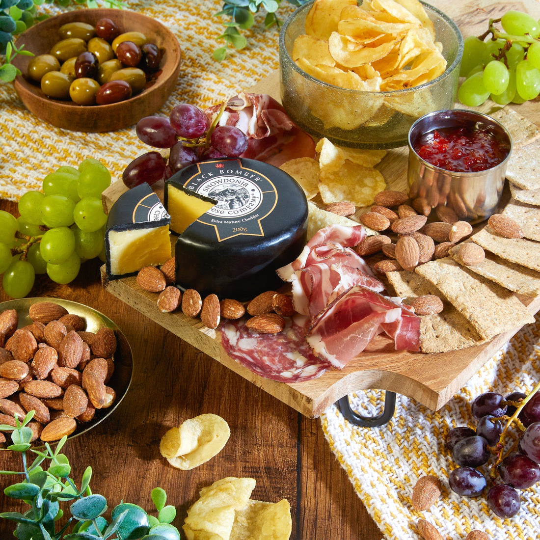 Charcuterie hamper contents displayed on wooden boards