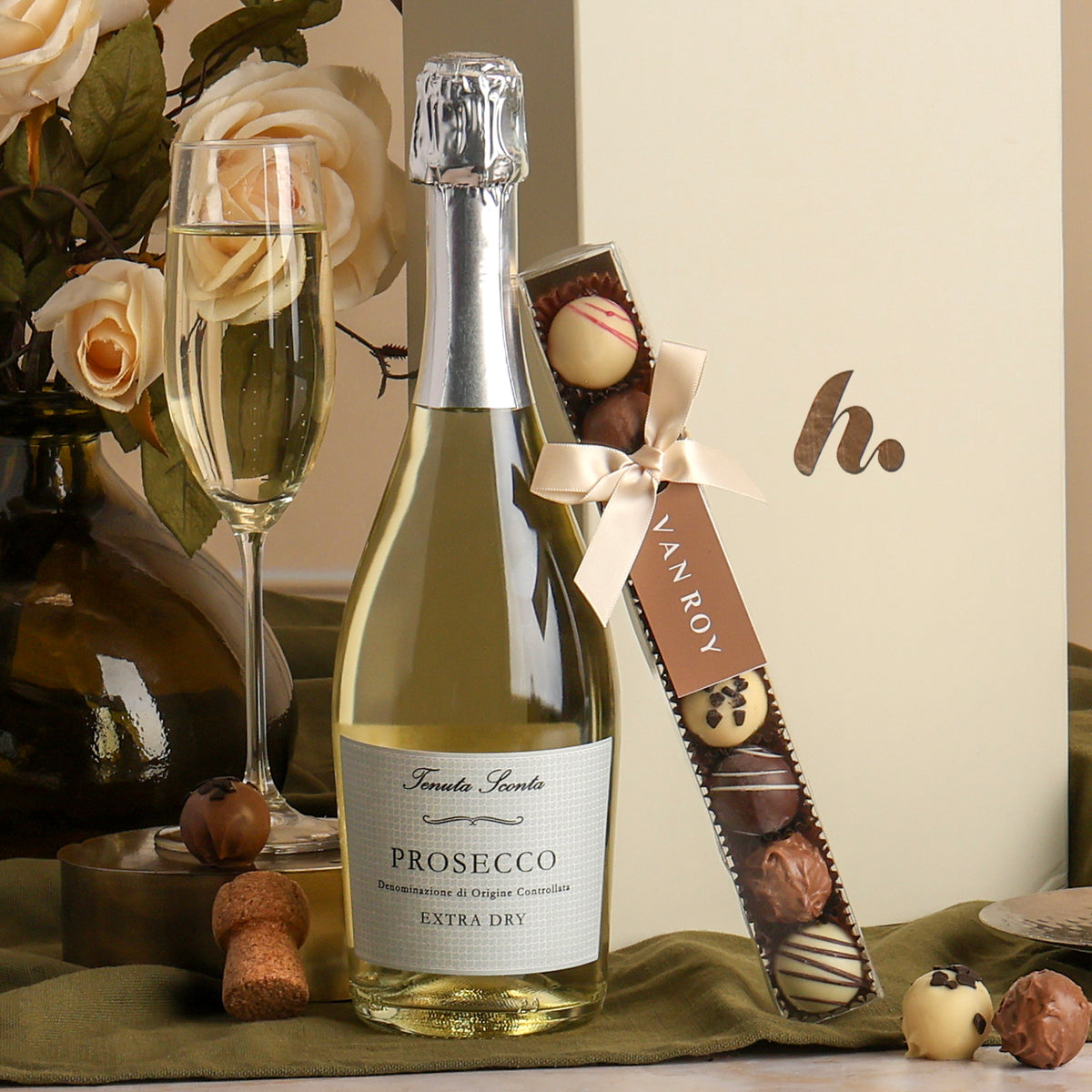Showing the bottle of Prosecco and chocolate truffles included in the Prosecco & Belgian Chocolates Hamper, a luxury gift hamper from hampers.com UK
