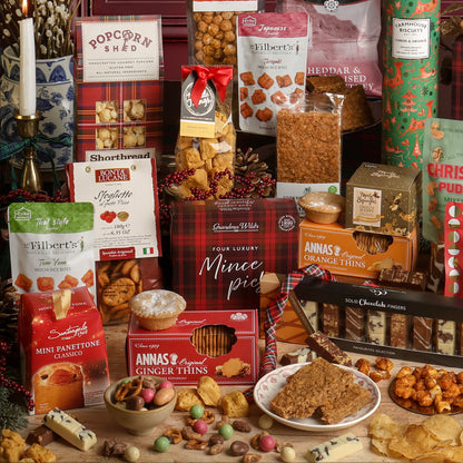 Christmas Party Sharing Box displayed showing many food items included with the gift, including mince pies, biscuits, panettone, popcorn, chocolate and savoury snacks. 