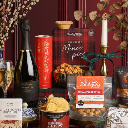 Holly Jolly Christmas Box hamper displayed showing its contents, including Prosecco, mince pies, popcorn, crisps and chocolate. 