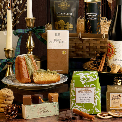 The Gold Standard Christmas Hamper displaying its contents, including a reusable bamboo tray along with a bottle of red wine and food items styled with festive decorations.