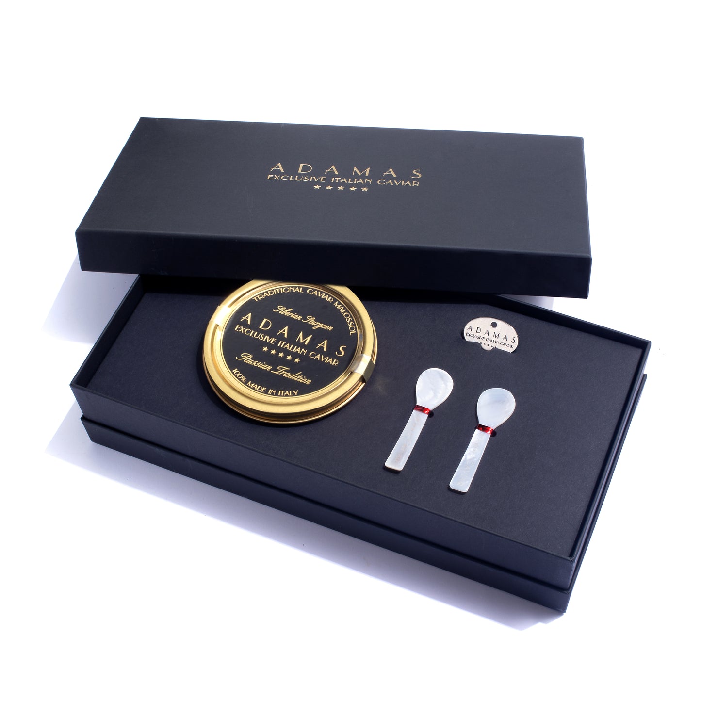 Adamas deluxe caviar gift set in a black presentation box, featuring a round tin of Prestige Selection caviar, two mother of pearl spoons, and a tin opener.