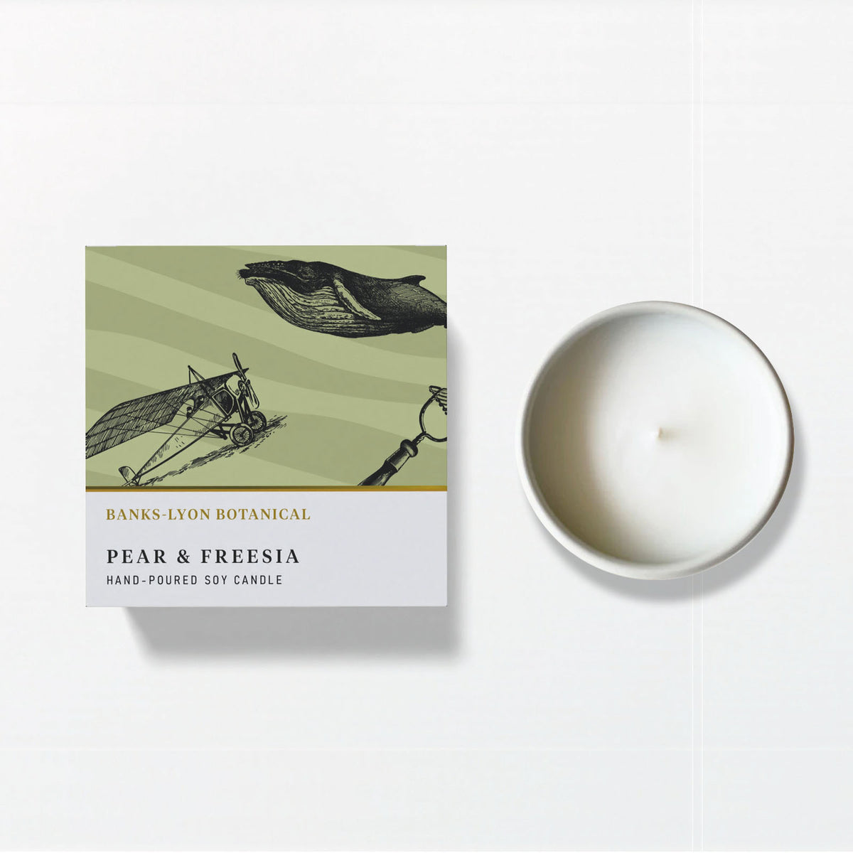 A Banks-Lyon Botanical Pear and Freesia hand-poured soy candle shown with its illustrated box on a white background.