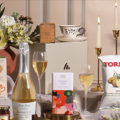 A luxury gift hamper to say thank you, showing contents including Prosecco, tea, chocolate and crisps.