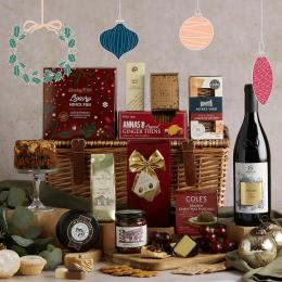 Image of a wicker basket with festive food and wine, with Christmas decoration illustrations