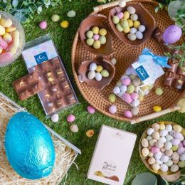 A flat lay photograph of Easter gifts, eggs and chocolate
