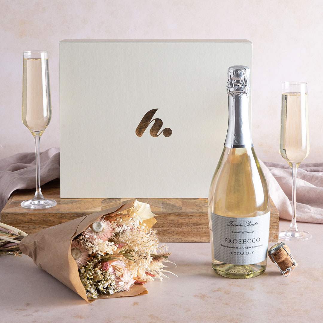 Dried Flowers and Prosecco gift box with contents on display and two flutes of fizz