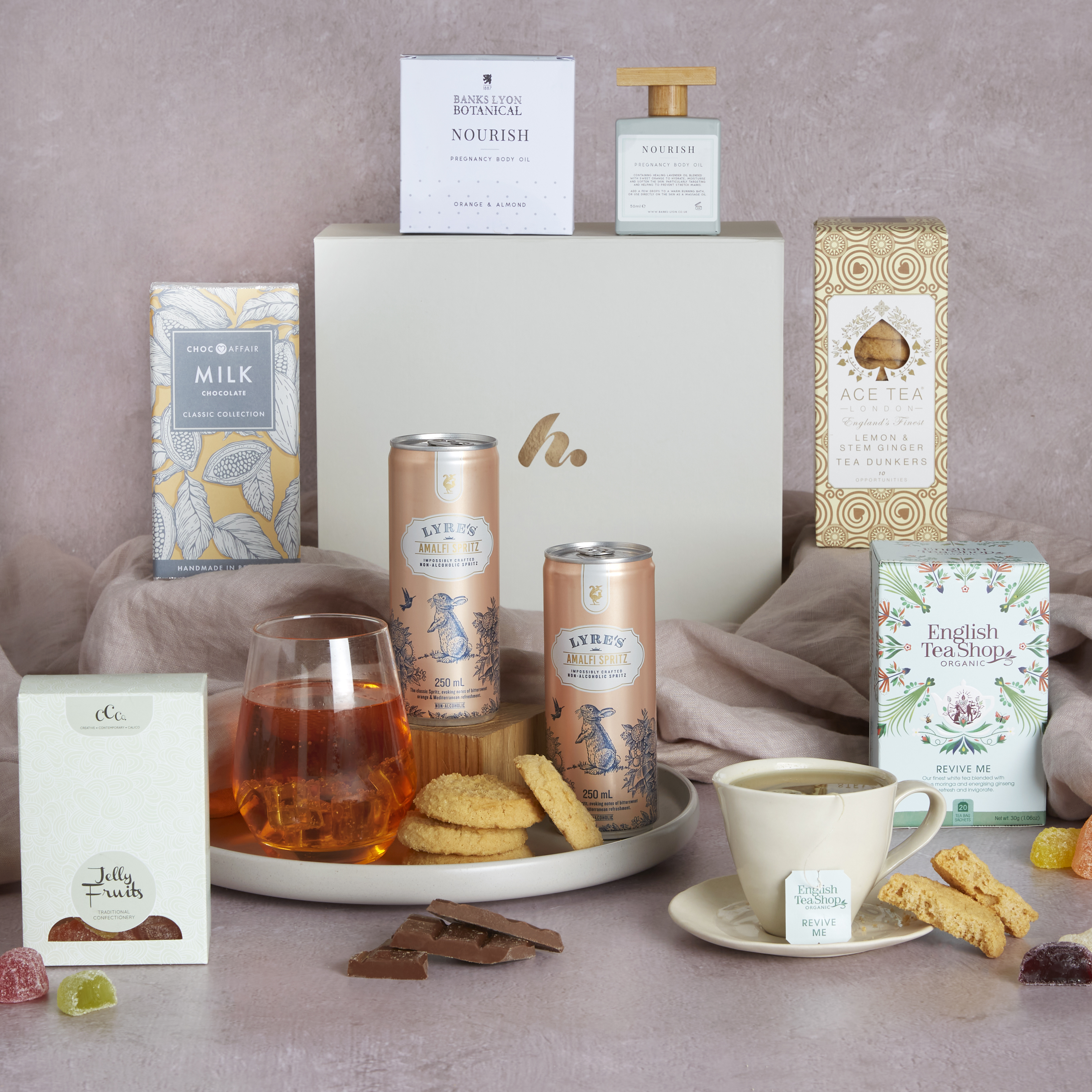 Mum-to-be pamper hamper with contents on display and signature gift box