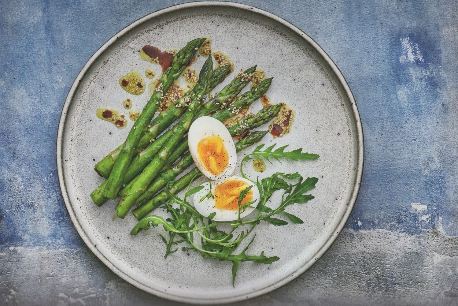 A plate with asparagus and eggs