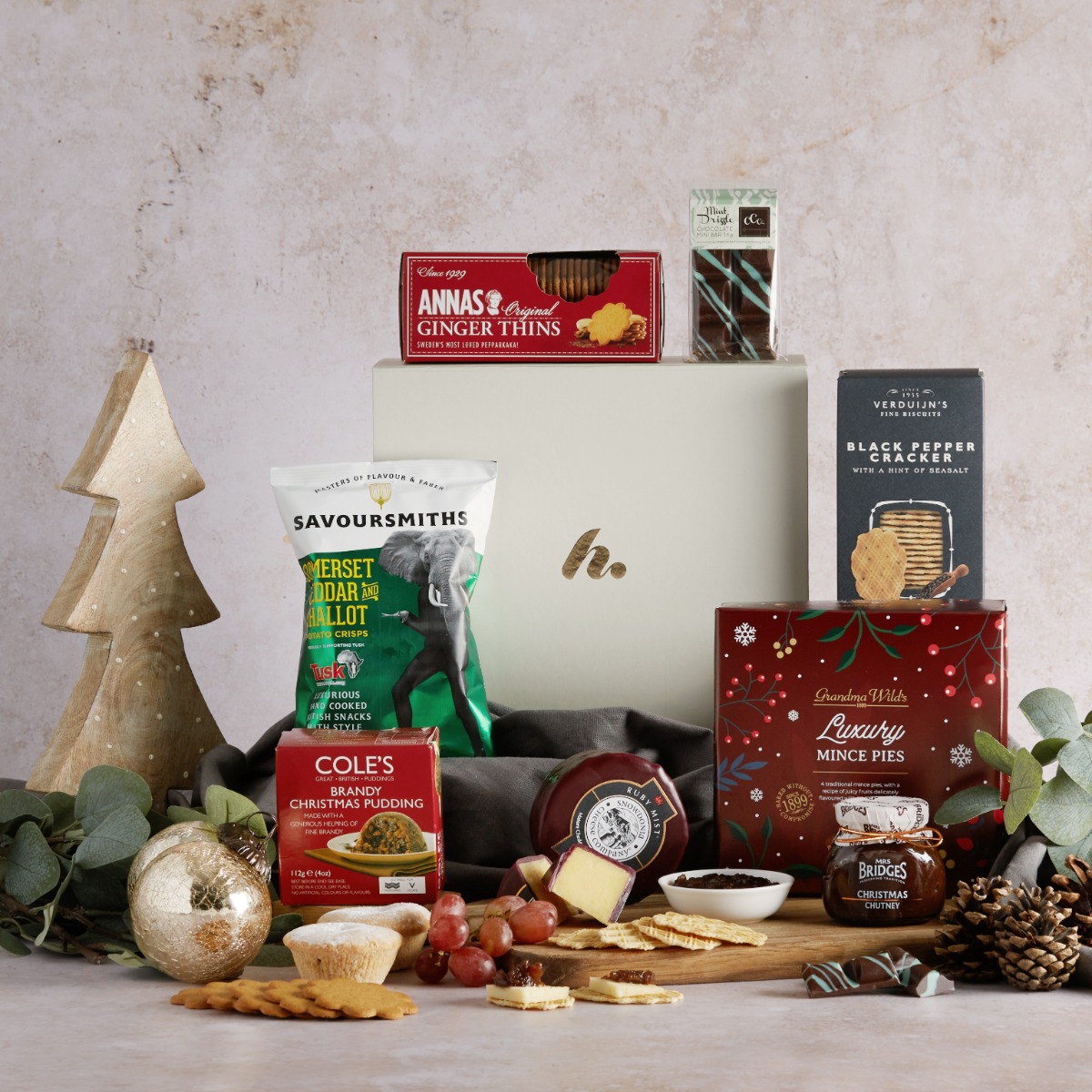 The Christmas Season Selection Gift Box with contents on display and a Christmas decoration