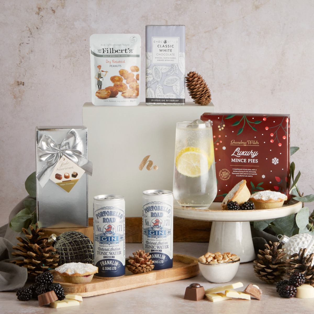 Festive Gin and Treat with contents on display and Christmas decor 