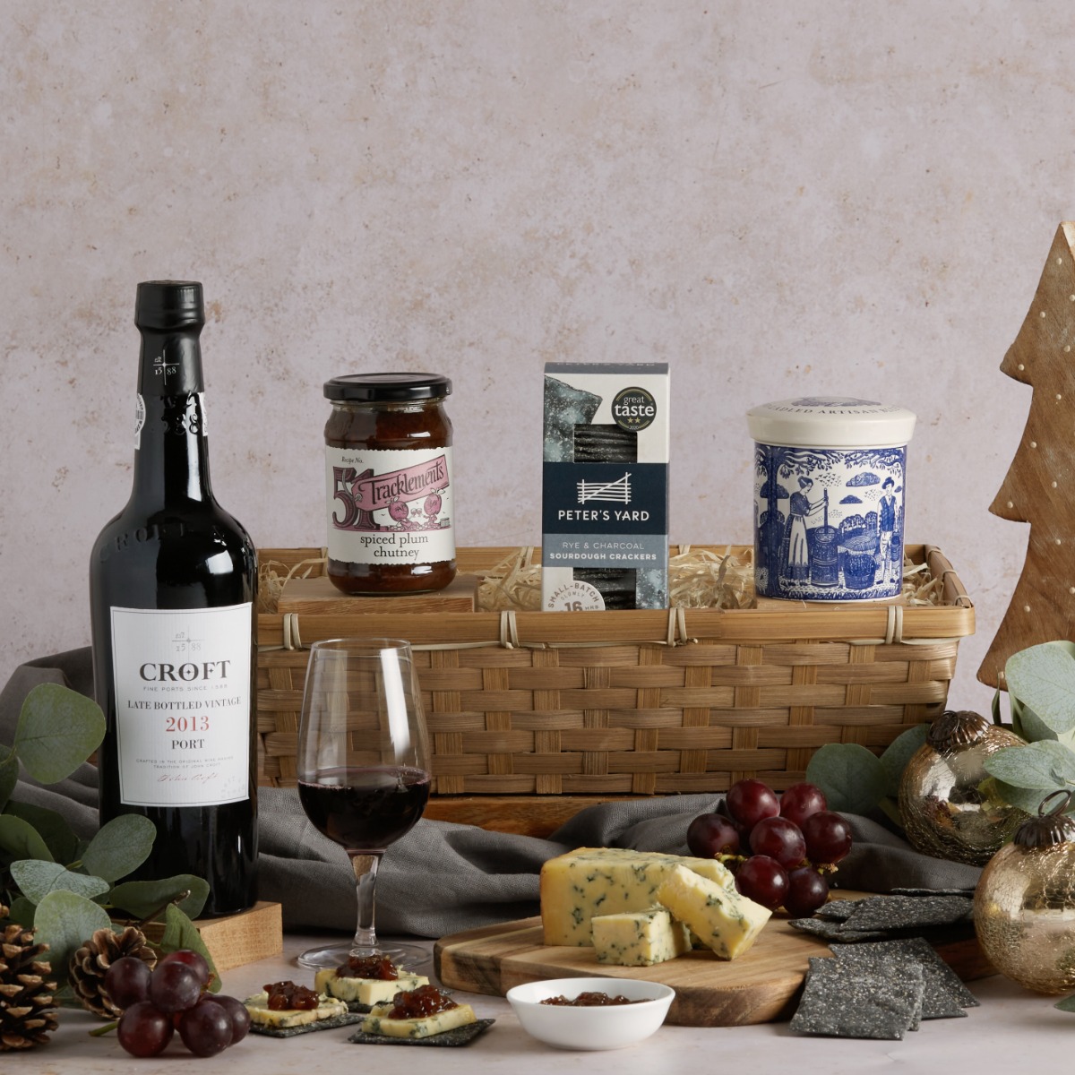 Luxury Port and Stilton Hamper with contents on display and Christmas decorations