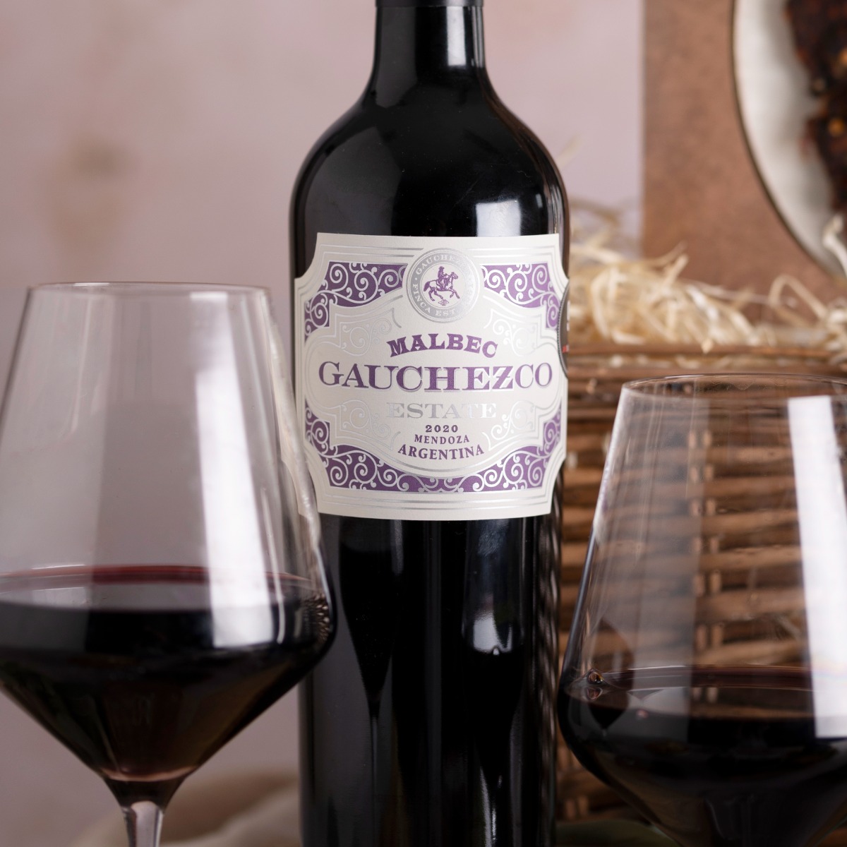 A close up of a bottle and glass of Gauchezco red wine