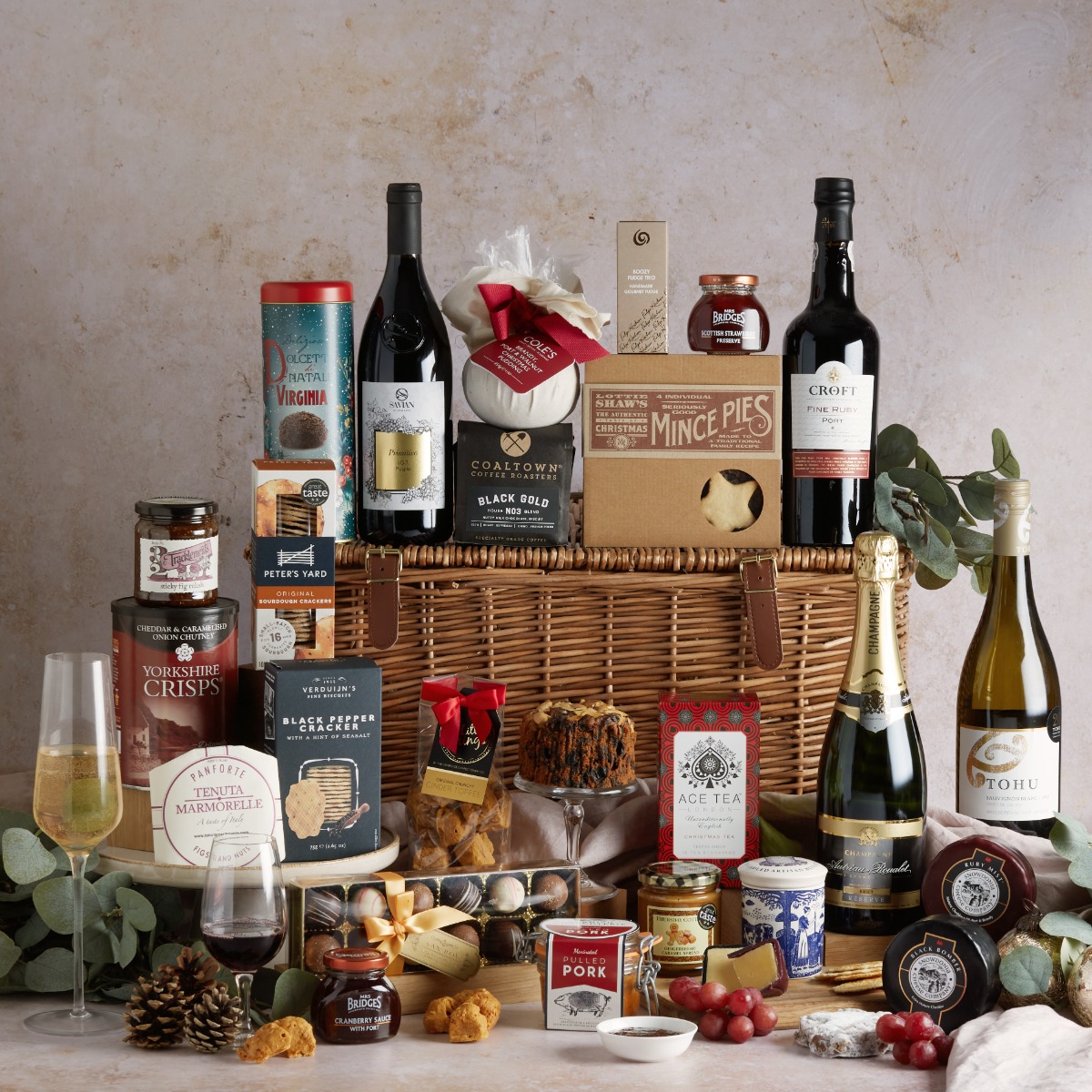 The Grand Christmas Hamper with large wicker basket and food and drink items on display
