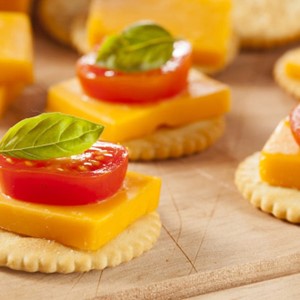 Cheese with a cracker tomato and basil