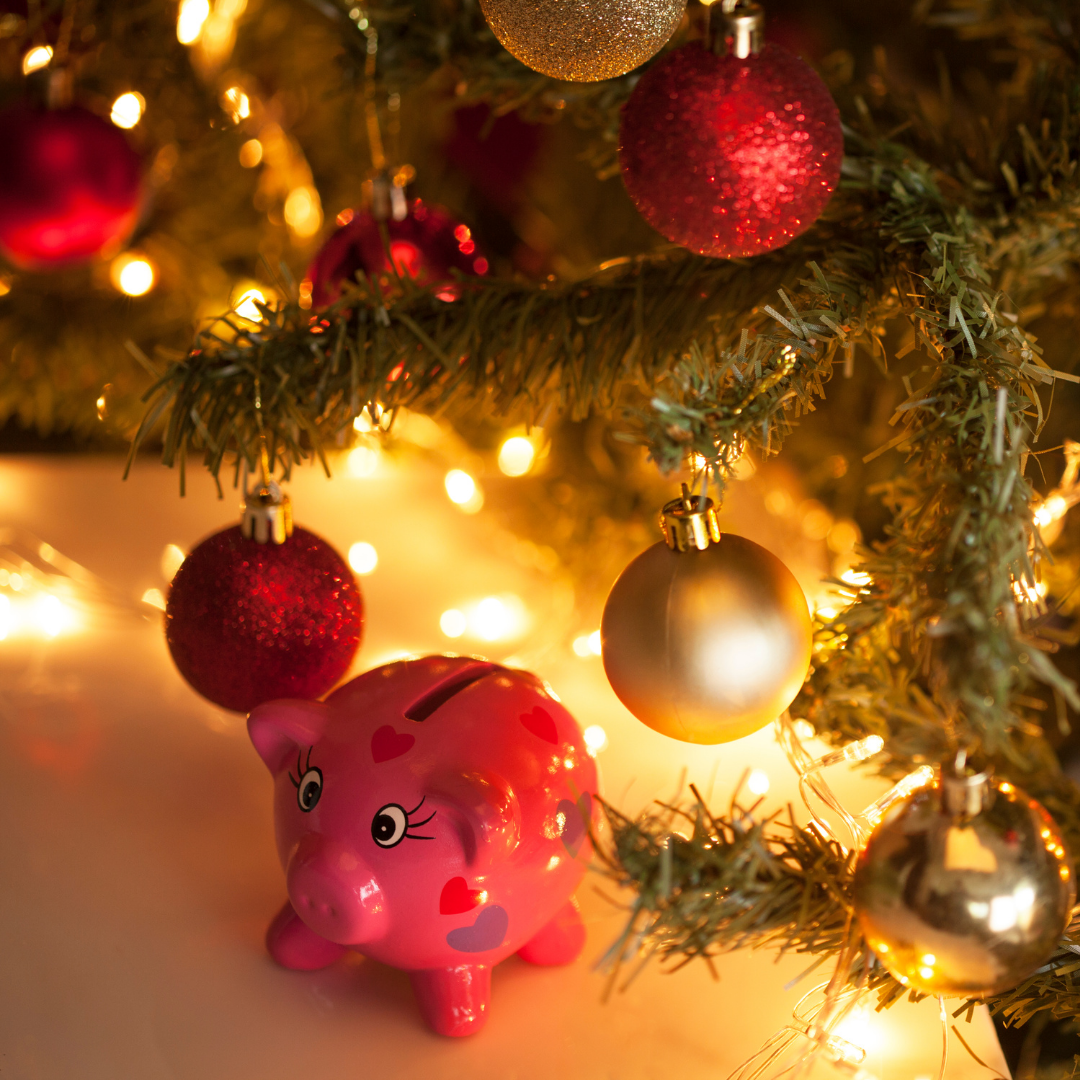 Christmas tree, decorations, gifts and a pink piggy money bank