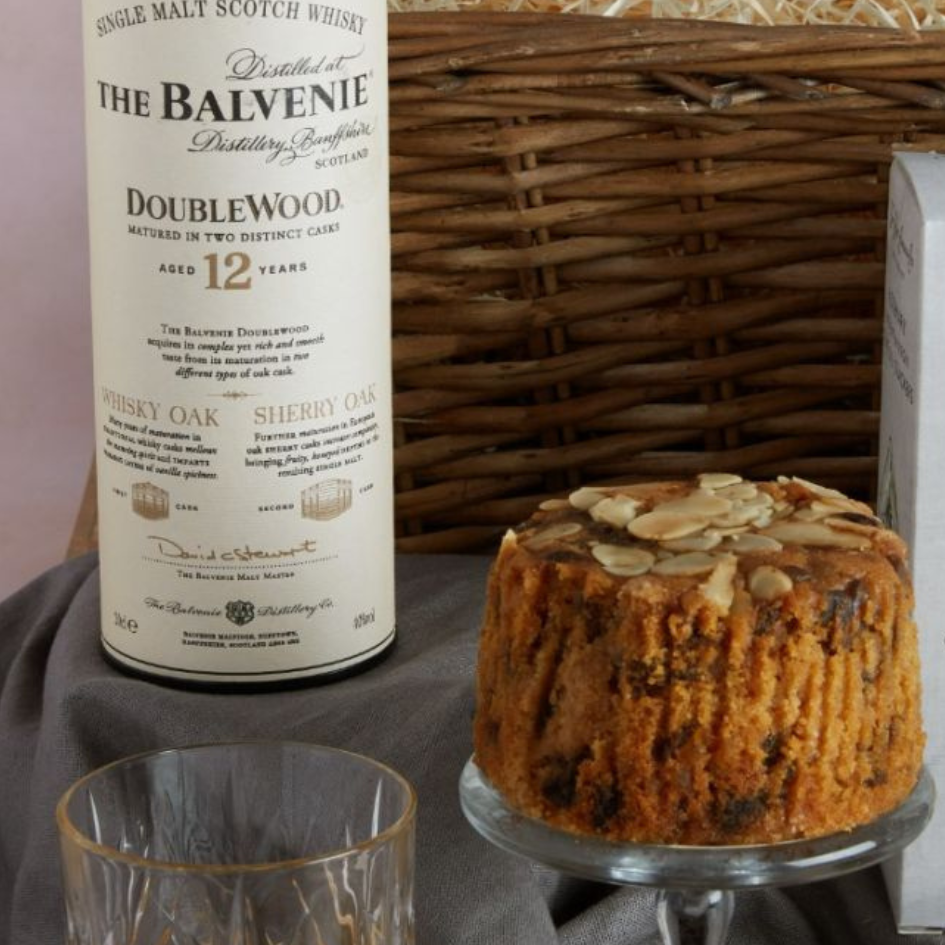 Close up of Dundee Fruit Cake and bottle of whisky