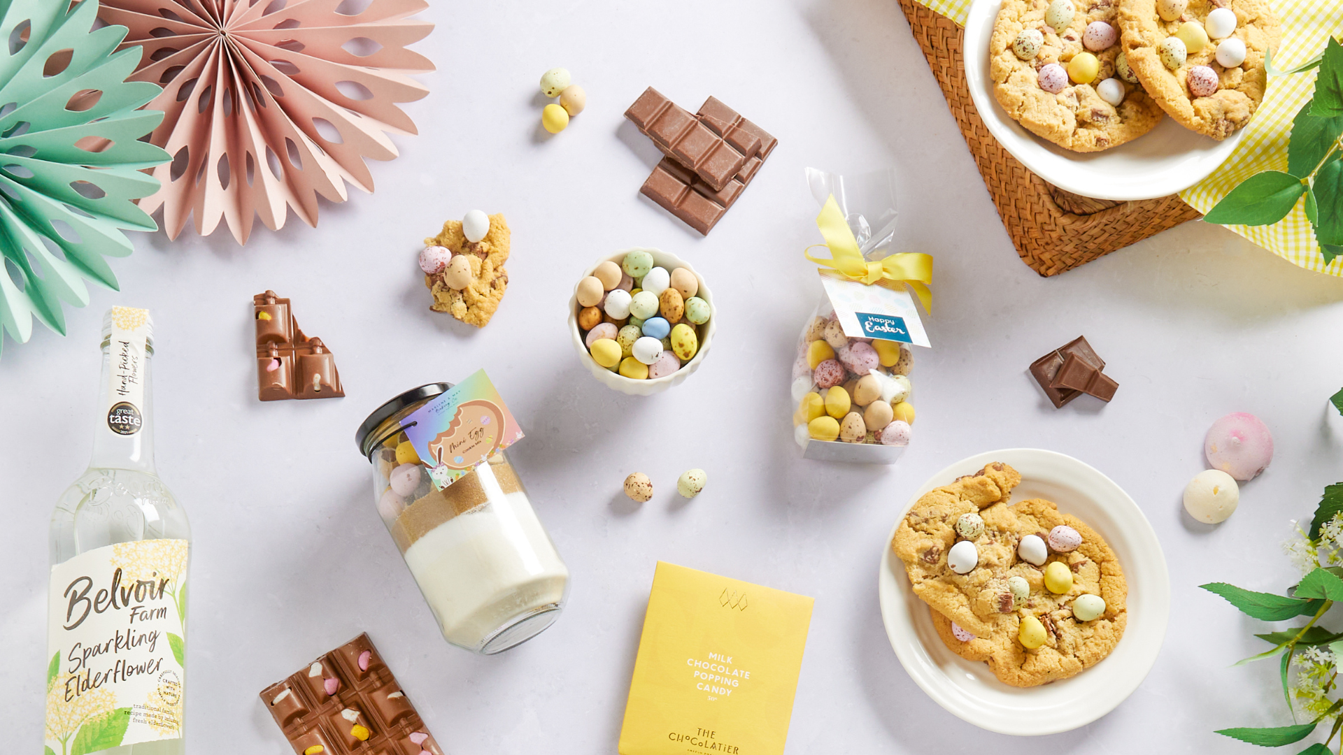 Flat lay of Easter products from hampers.com Easter gifts, including chocolate eggs and cookies