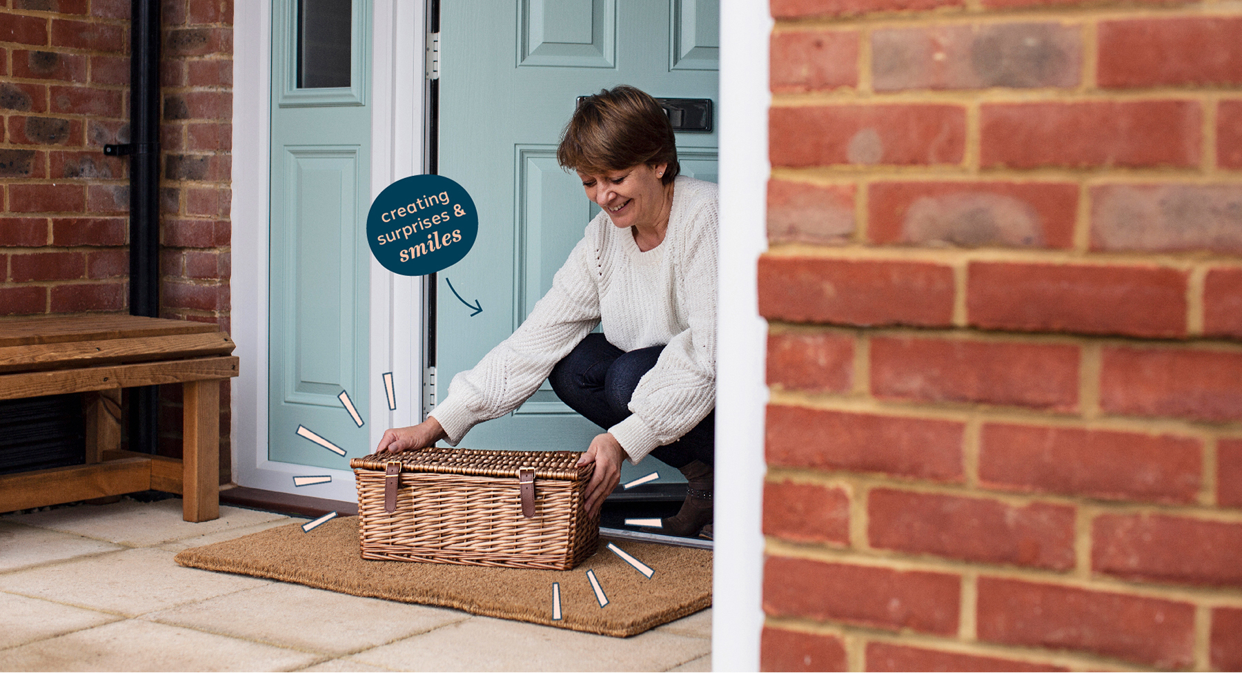 Someone collecting a hamper from their front doorstep