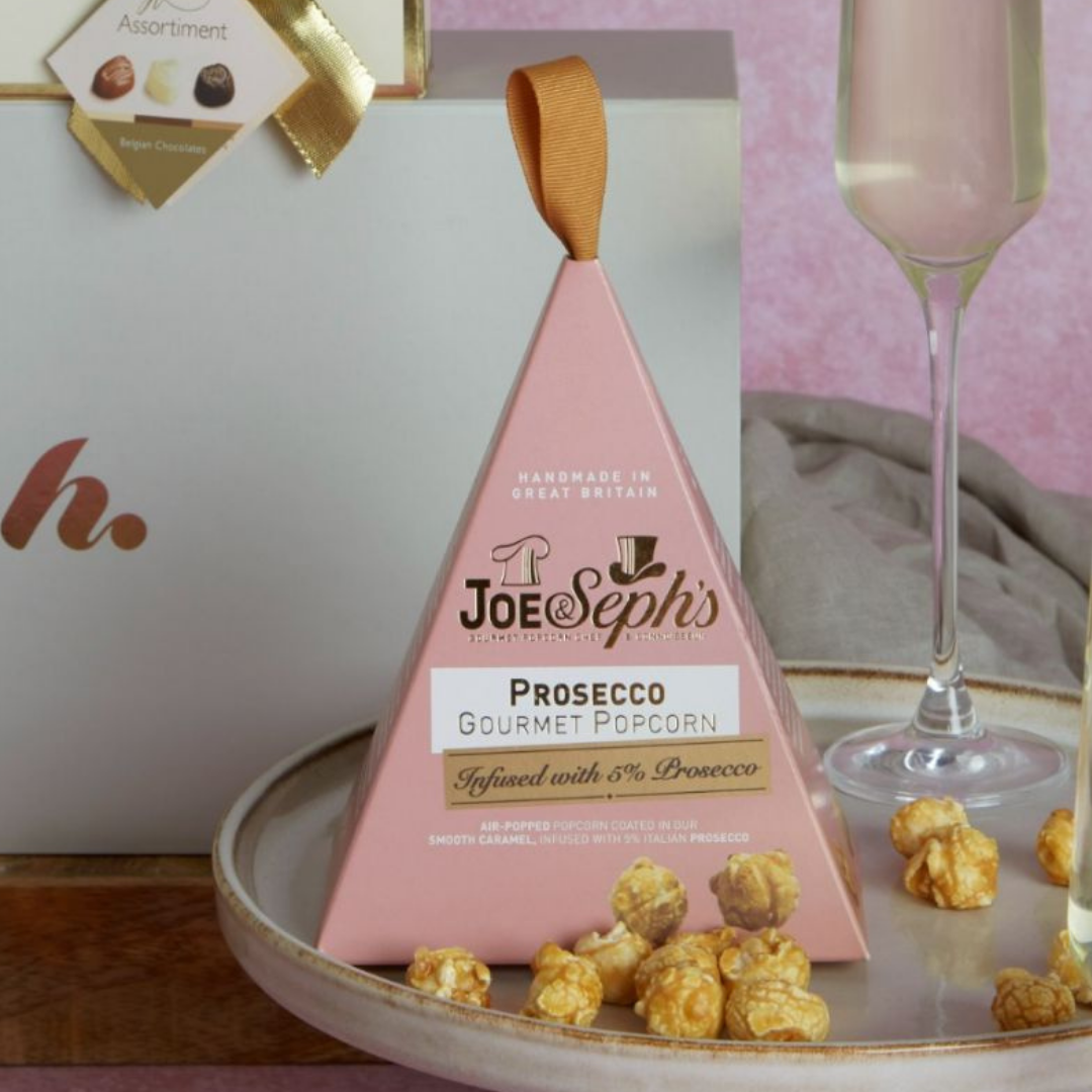 Close up of Joe & Seph's popcorn gift box, with hampers.com gift box in background