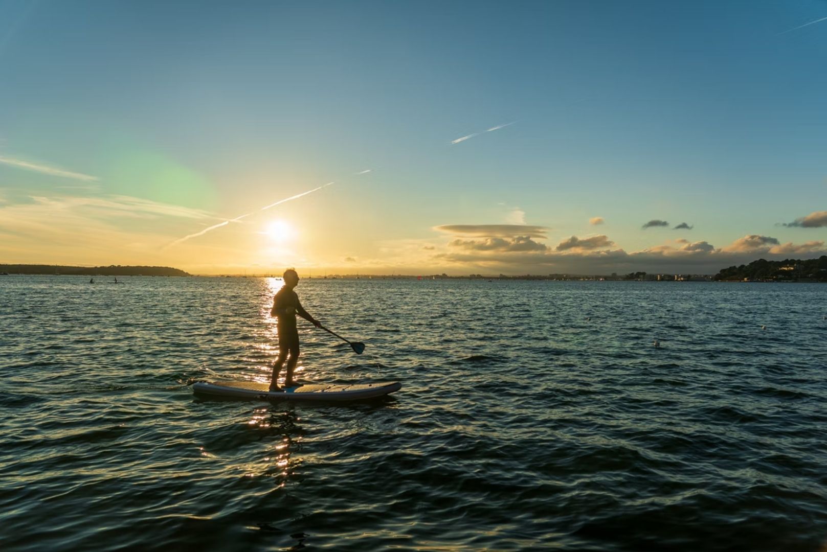 Man on paddleboard in sunset