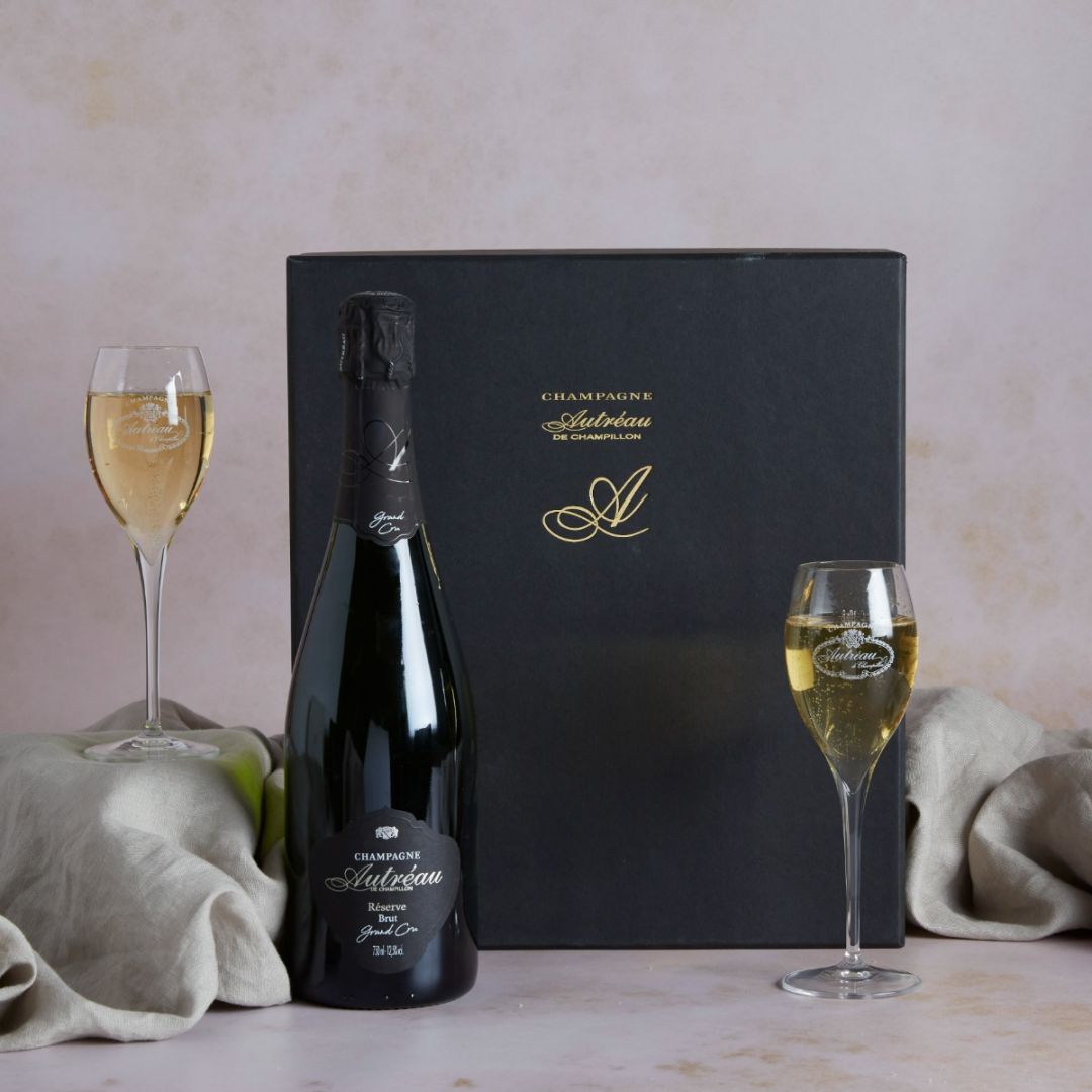 Grand Cru Champagne and Glasses Gift Set with contents and flutes of Champagne on display
