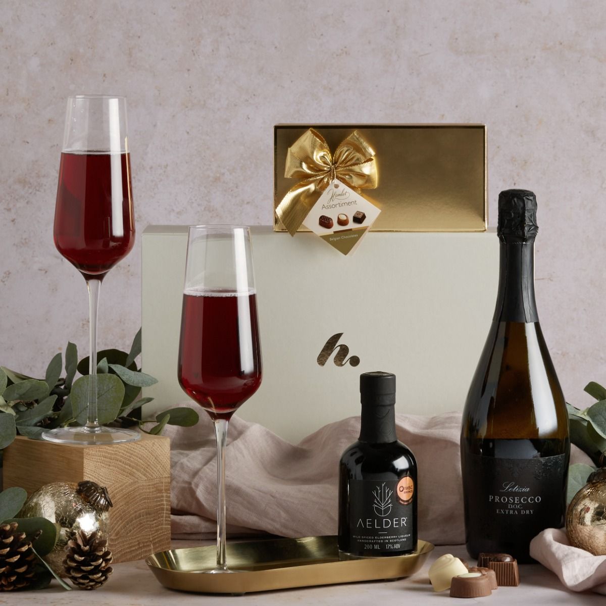 Bottle of Prosecco and Aelder elixir with glasses showing them combined in a unique version of kir royale