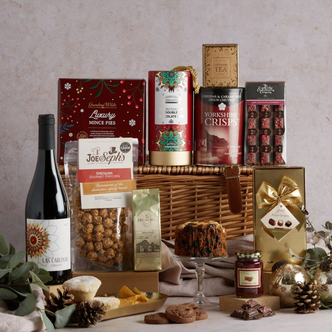 Jingle Bells Christmas hamper with contents on display, including a wicker basket