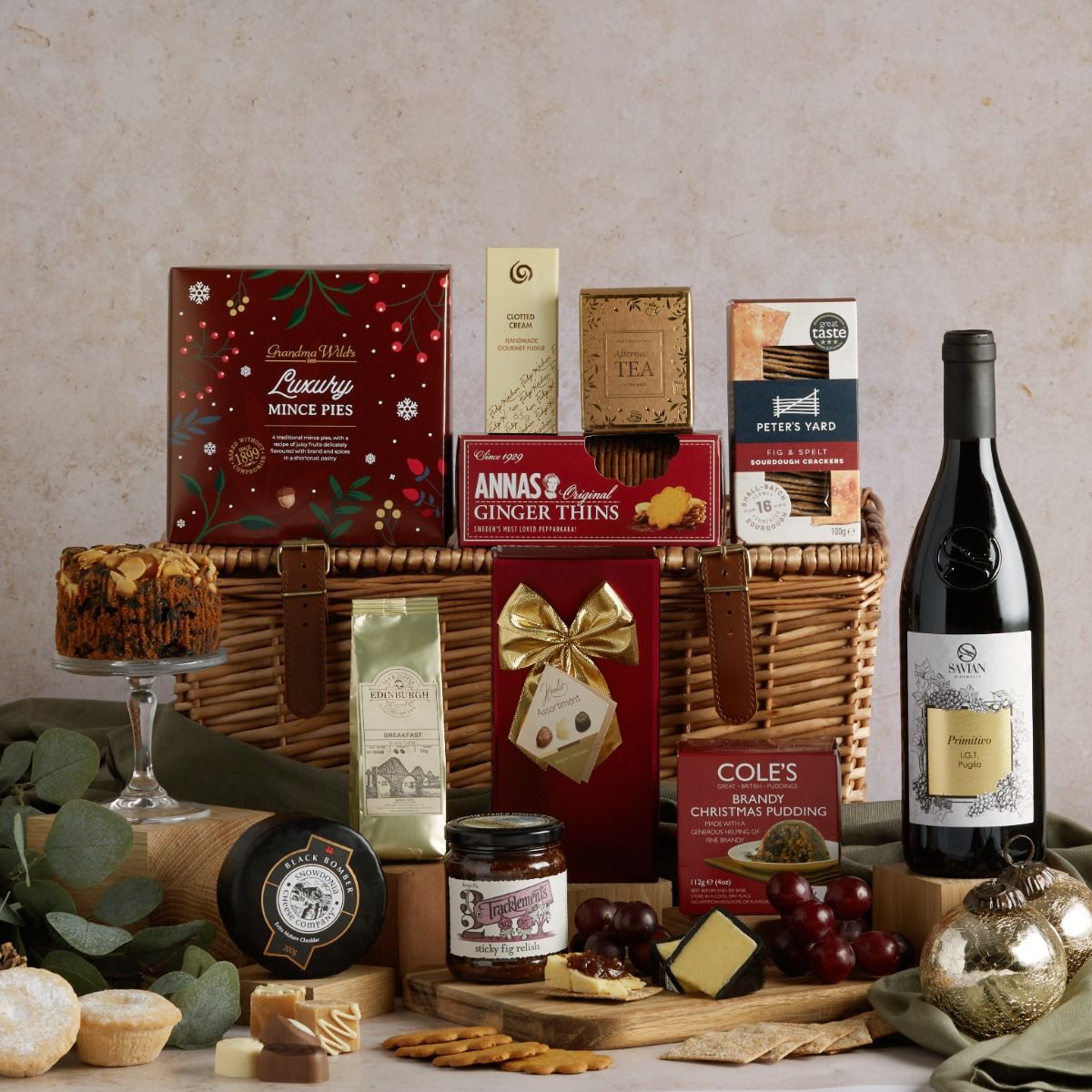 Luxury Christmas Cracker Hamper with contents on display and the wicker basket