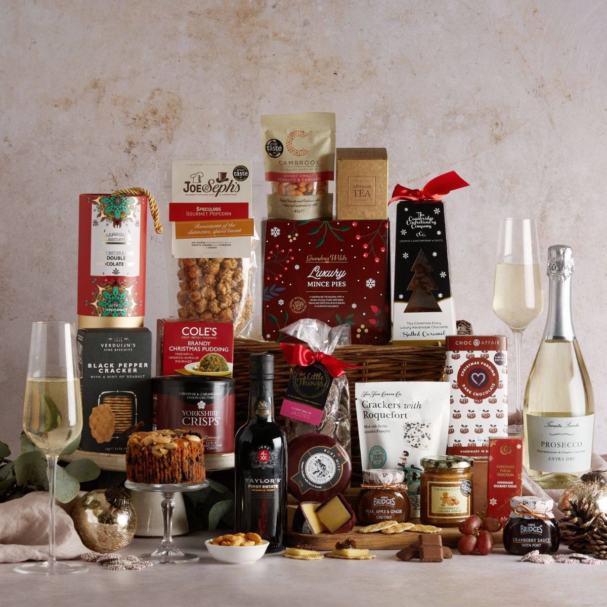 The Family Christmas Hamper with contents on display and wicker basket