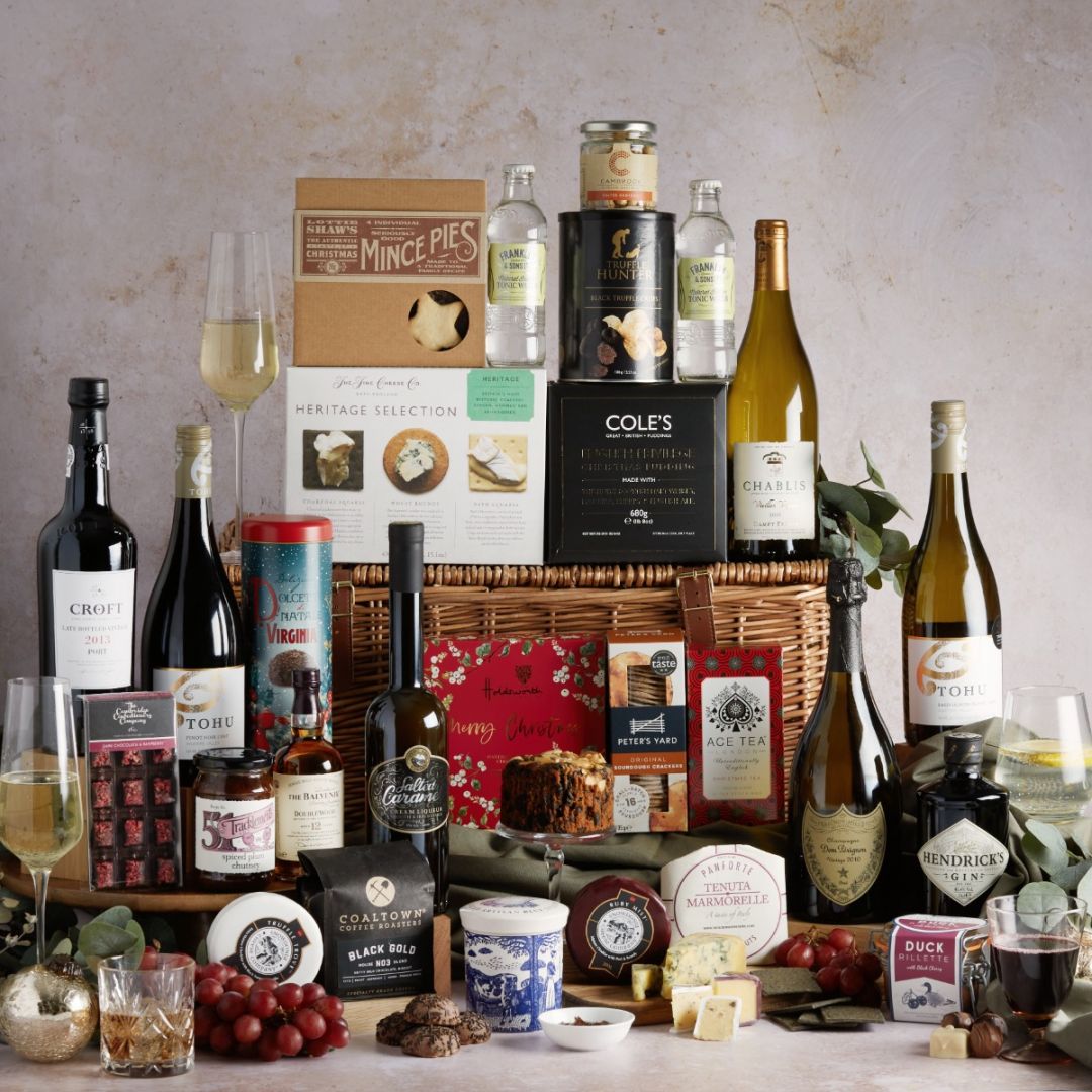 The ultimate Christmas hampers with all of its contents on display with a lidded wicker basket