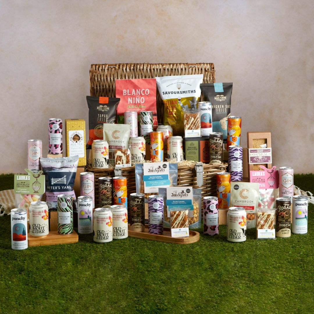 The Grand Garden Party Hamper with all of its contents on display and a keepsake picnic basket