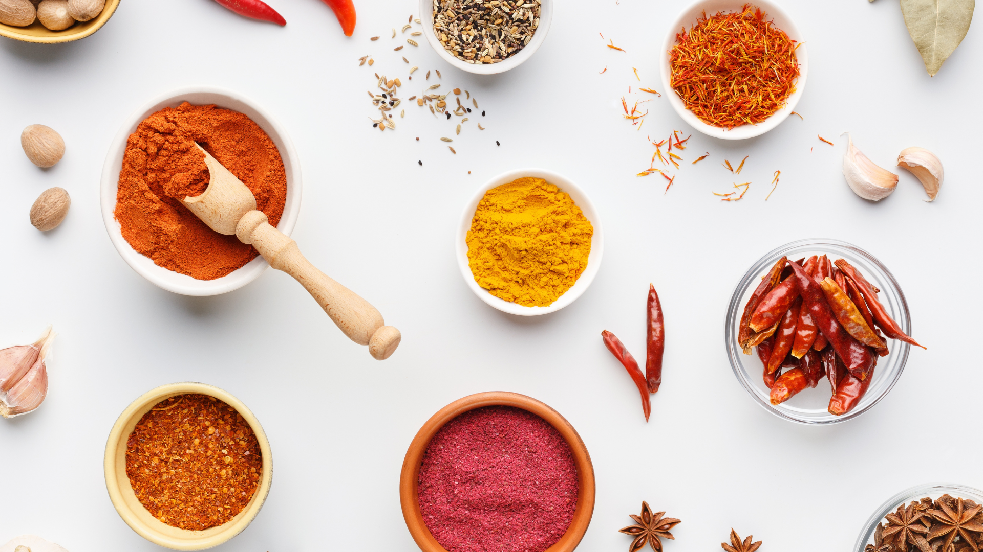 Flat lay image of spices in different bowls