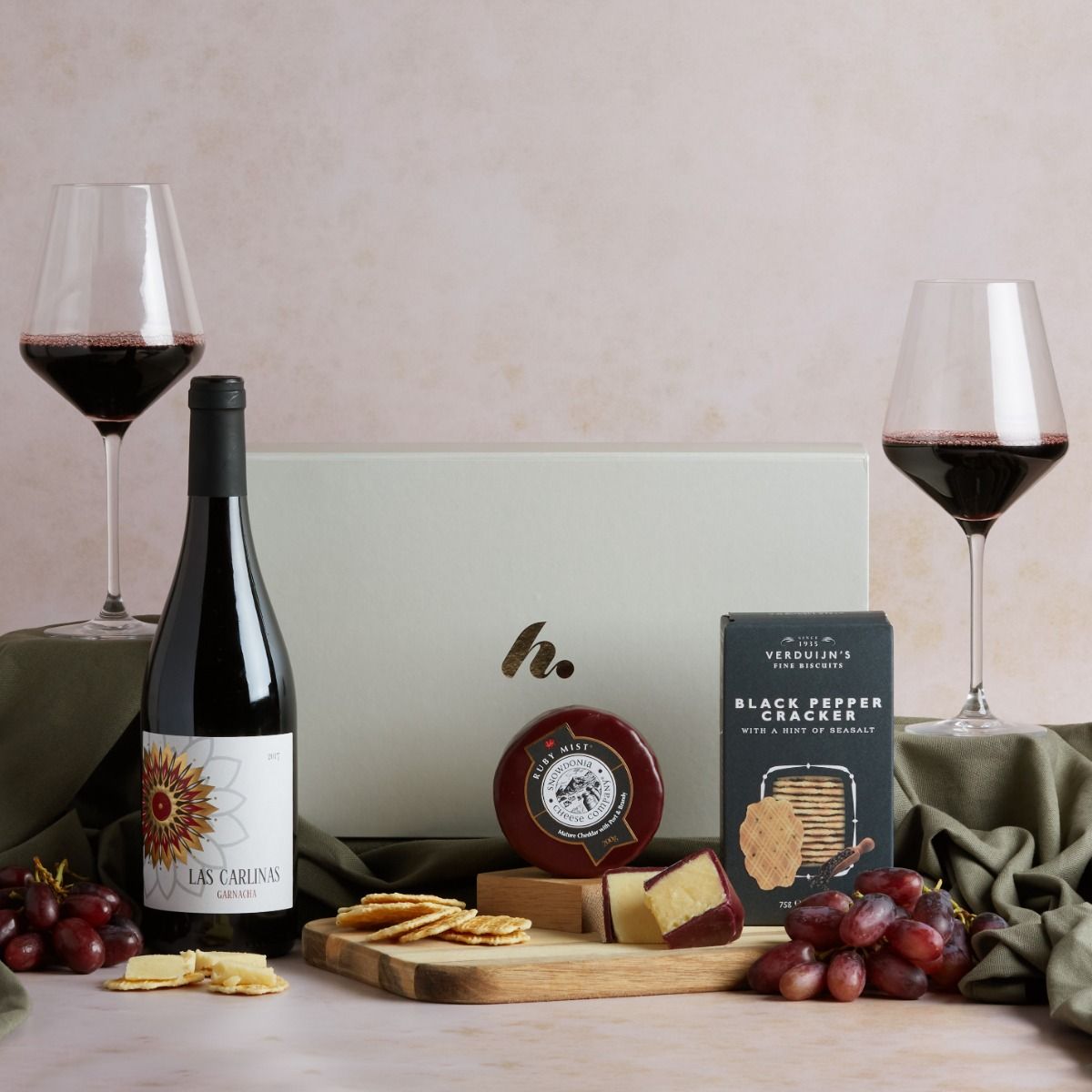 Classic Wine and Cheese Hamper with contents on display, two glasses of red wine and a signature cream gift box