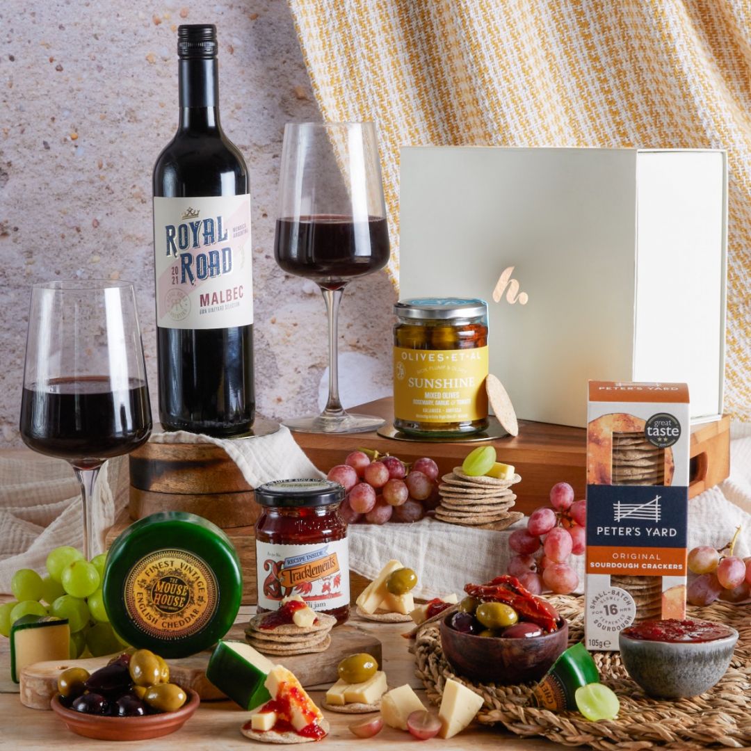  Gourmet Cheese & Wine Gift with contents on display and red wine for a New Year's eve treat